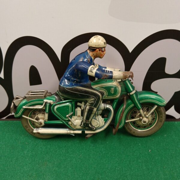Vintage tin plate police motorcycle toy, detailed and collectible.