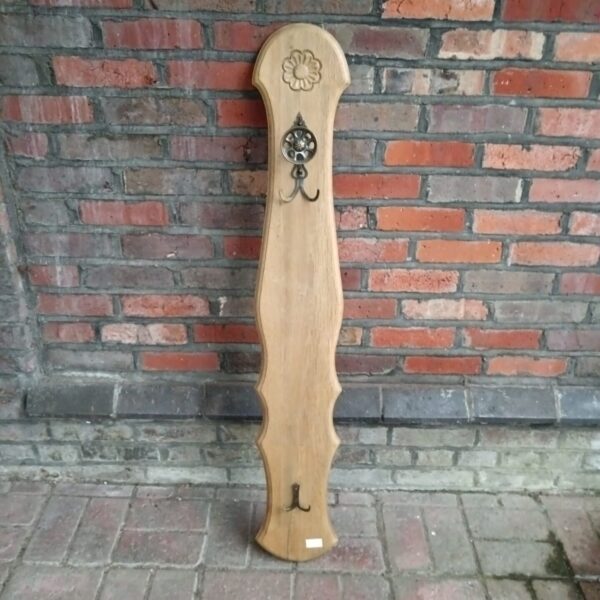 Vintage light oak coat rack with multiple hooks for hallway storage.