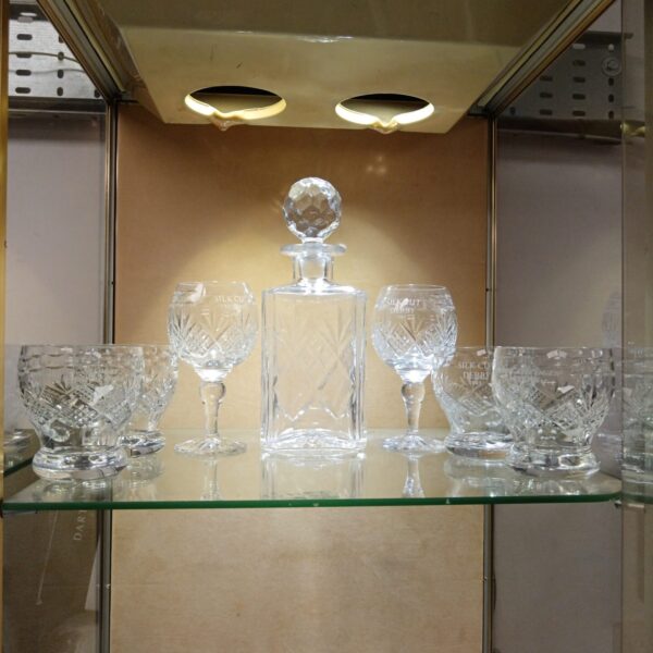 Vintage glass decanter set with branded glasses, collectible barware.