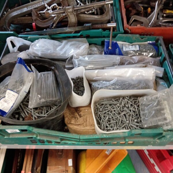 Large tray filled with galvanised nails for DIY projects.