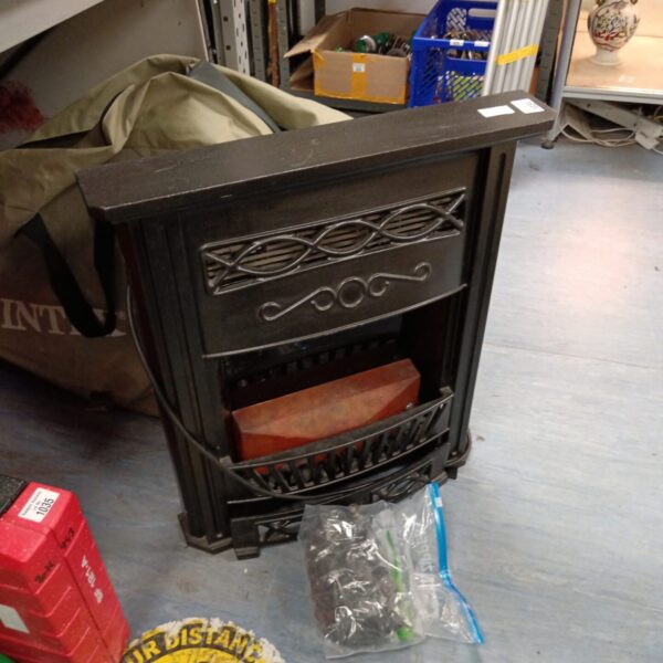 Vintage cast iron electric fireplace with decorative surround.