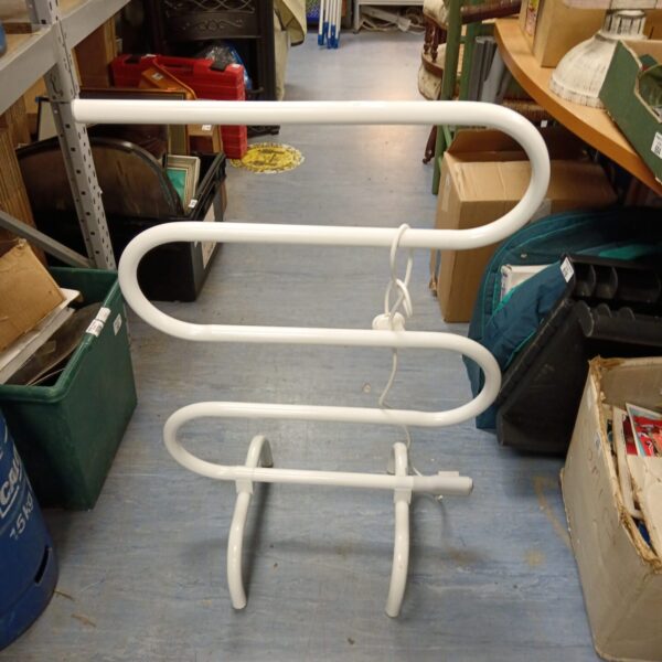 Vintage chrome electric towel heater for bathroom use.