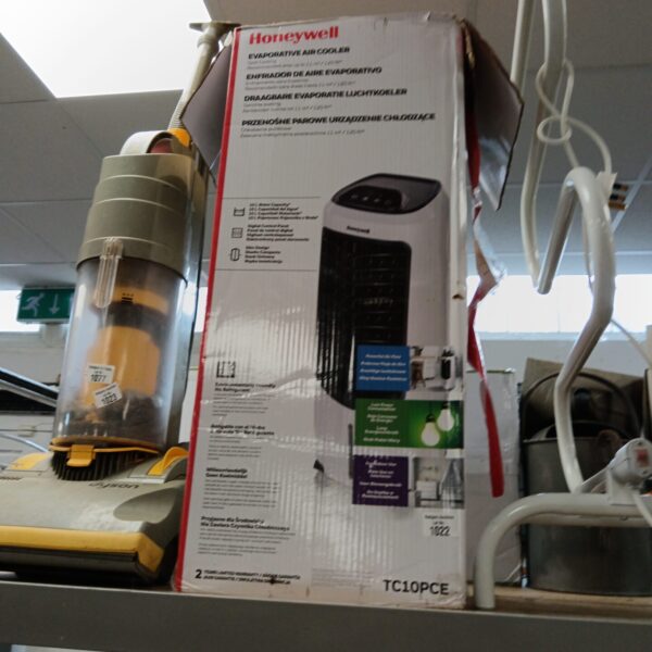 Honeywell evaporative cooler in original packaging, side view.