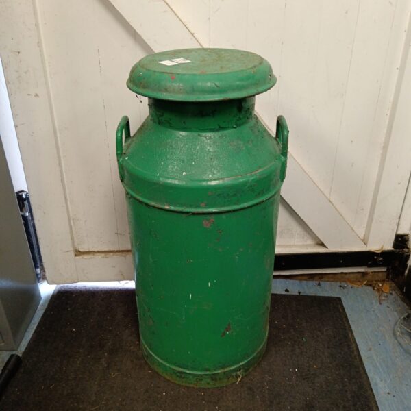 Front view of a vintage metal milk churn.