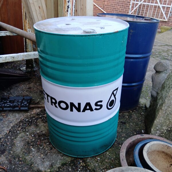 Front view of a large, empty Petronas oil barrel.