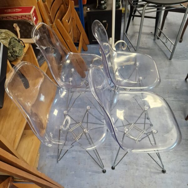Set of four clear perspex designer chairs with wire legs.