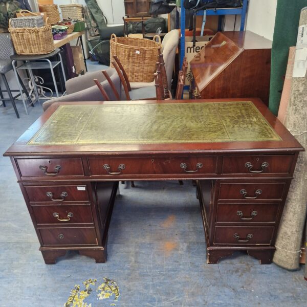 Antique mahogany executive desk with leather top.