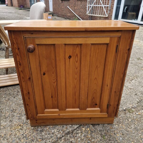 Front view of a vintage pine kitchen cabinet.