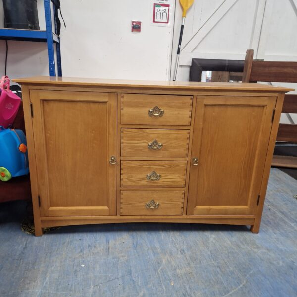 Vintage oak sideboard with drawers and cupboards for storage.