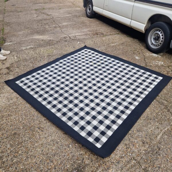 Black and white chequered Ikea rug in a room setting.