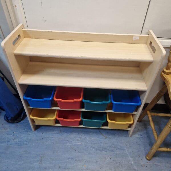 Colourful childrens storage unit with plastic boxes for toys.