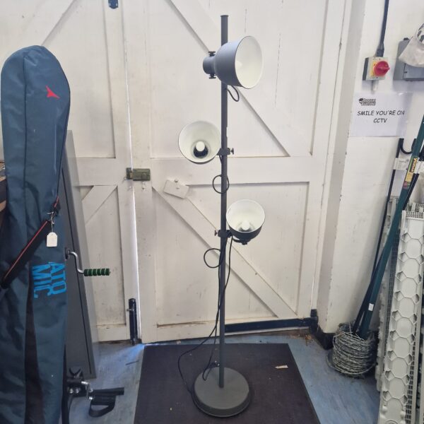 Vintage industrial spotlight standard lamp with adjustable heads.
