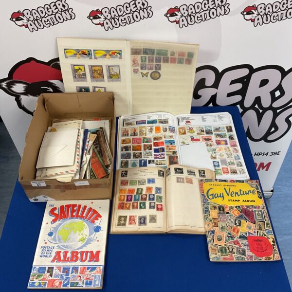 Vintage stamp albums and postcards in a mixed lot for collectors.