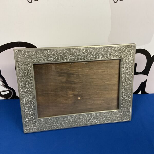 Vintage silver daisy photo frame for displaying cherished photos.