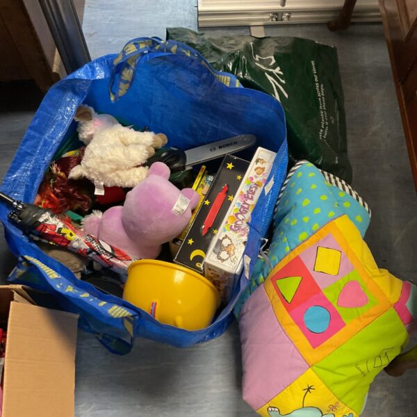 Mixed toy lot with kids costumes and colourful blanket.