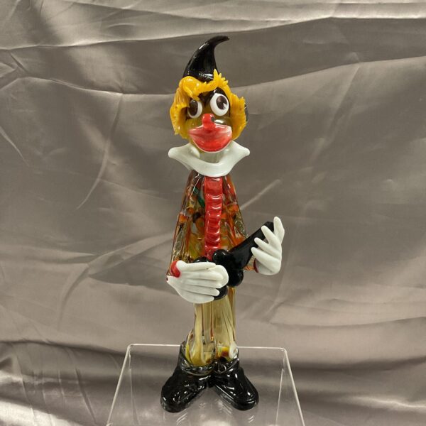 Vibrant Murano glass clown musician figurine with colourful costume.