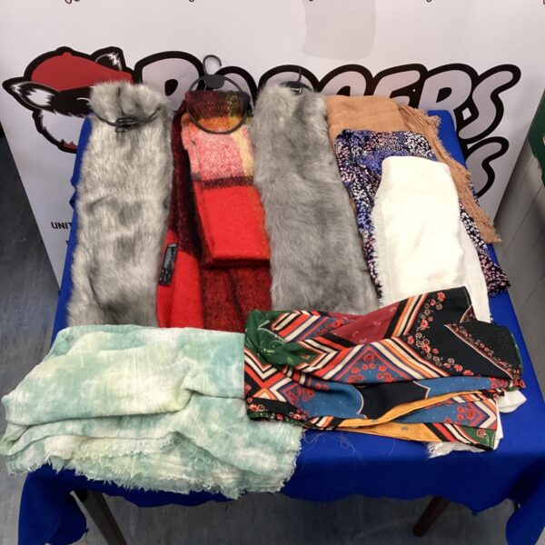 A colourful lot of silk scarves presented for auction.