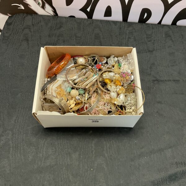 Assortment of vintage costume jewellery including necklaces and brooches.