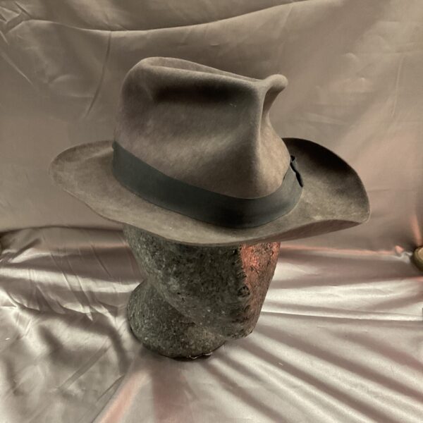 Vintage Christie’s of London trilby hat displayed on a stand.