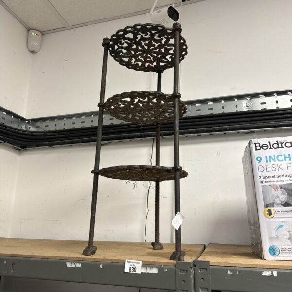 Vintage wrought iron tiered plant stand for garden or home display.