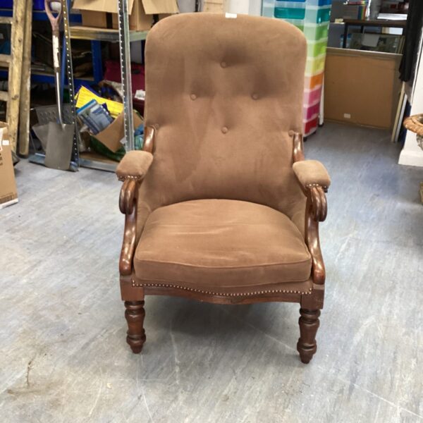 Brown vintage button back chair with open arms.