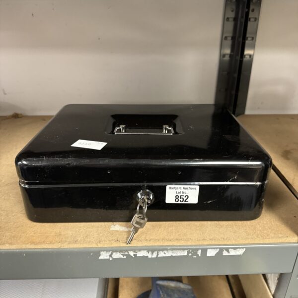 Large metal cash tin with a lock, secure money storage.