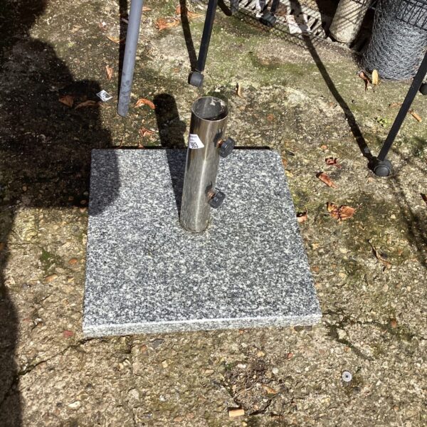 Grey speckled garden parasol stand for patio umbrellas.