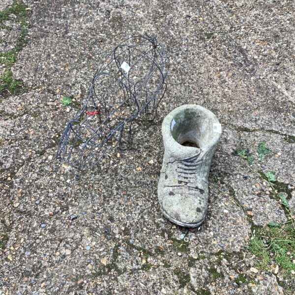 Stone effect garden boot planter with pig wire frame.