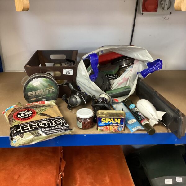 A mixed lot of fishing tackle including reels, lines, and bait.
