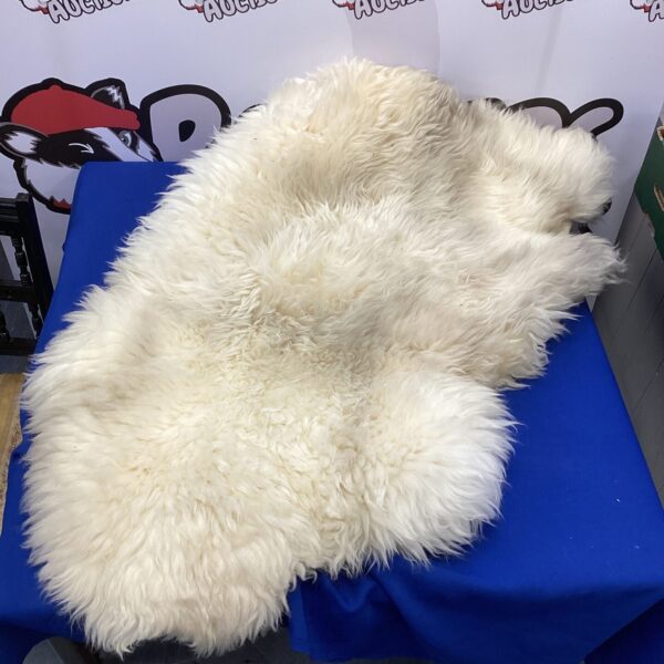 Natural sheepskin car seat cover for vehicle comfort.