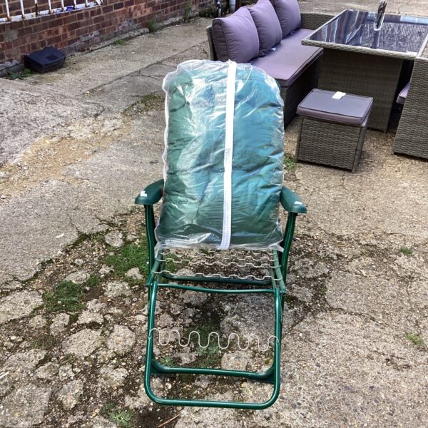 Cushioned reclining garden chair in a garden setting.