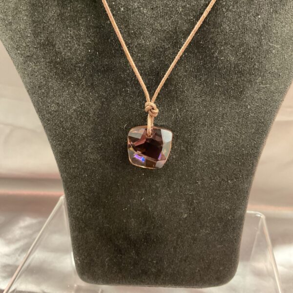 Close-up of a Swarovski amber crystal pendant necklace.