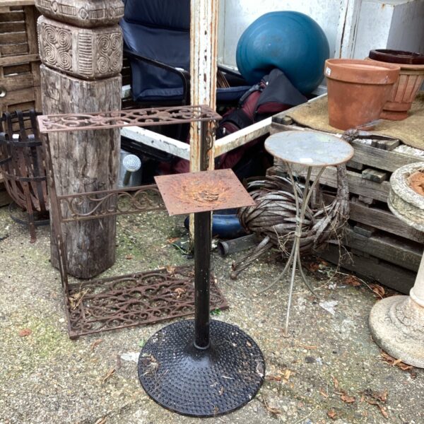 Black metal garden table in a patio setting.