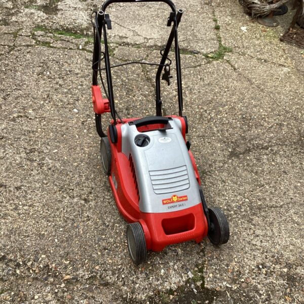 Wolf battery lawn mower in a garden setting.