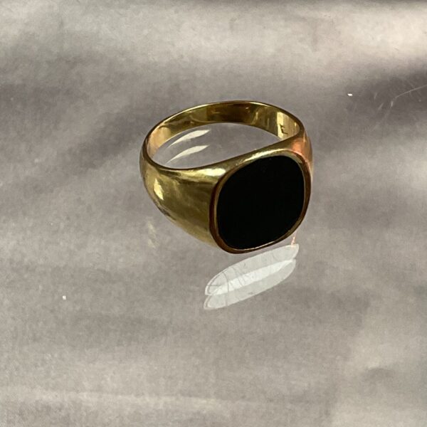 Vintage yellow metal ring with black onyx stone.