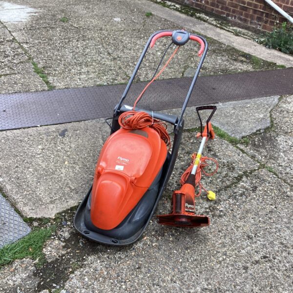 Orange Flymo electric lawn mower and strimmer set for garden use.