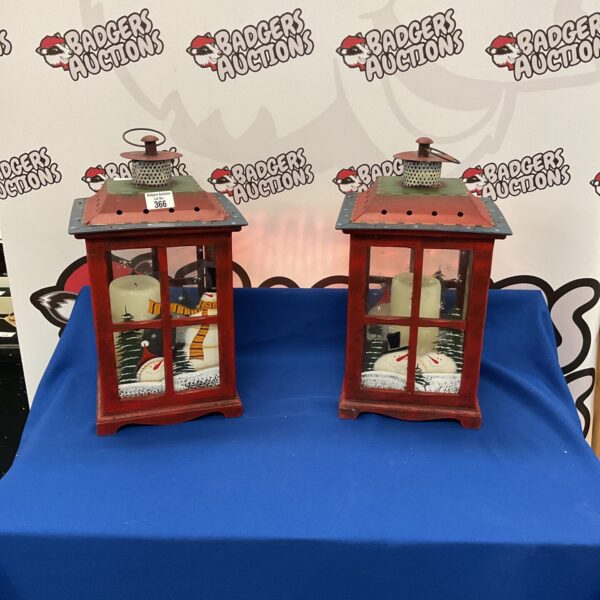Pair of vintage Christmas lanterns with festive winter scenes.