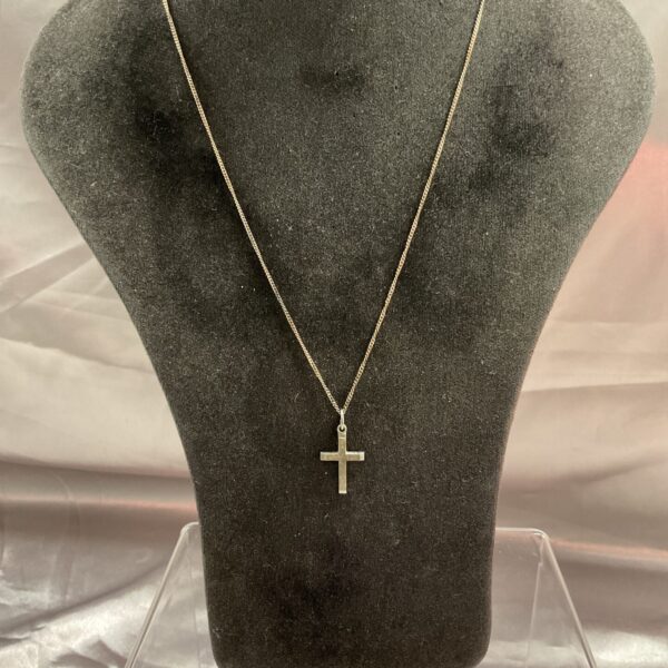 Close-up of a 925 silver cross pendant on a silver chain.