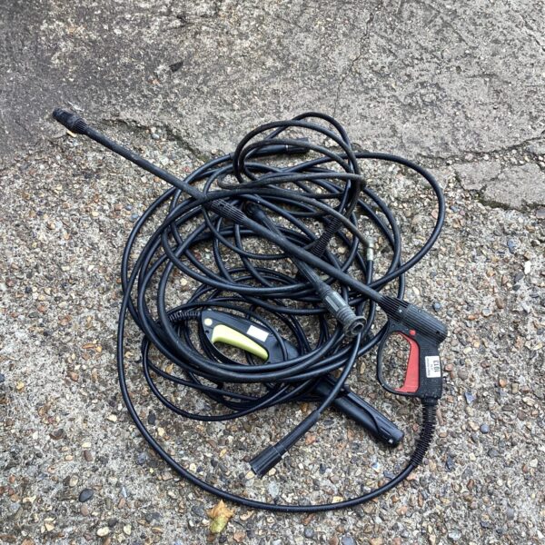 Used pressure washer hose with connection points for cleaning equipment.