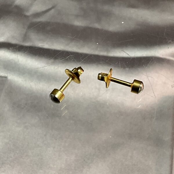 Close-up of 9ct gold stud earrings, showcasing their classic design.