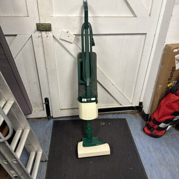Vintage Vorwerk VK 121 cylinder vacuum cleaner in a domestic setting.