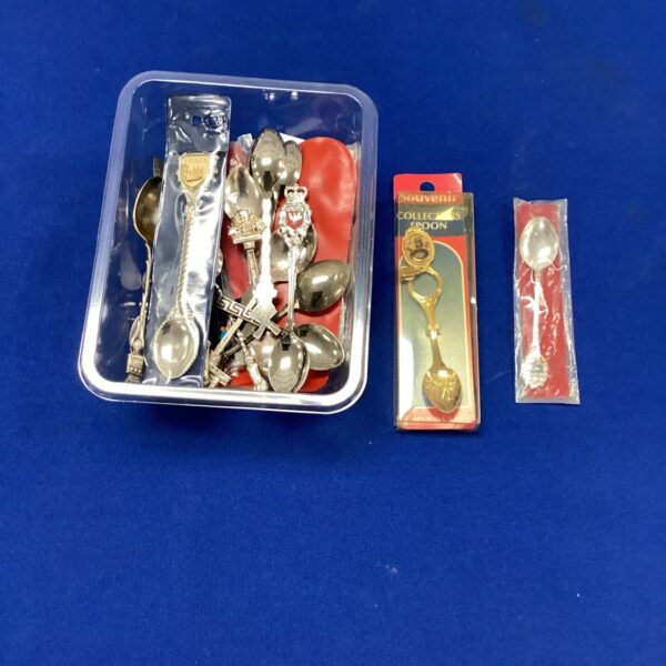 Vintage souvenir tea spoon collection with decorative finials.