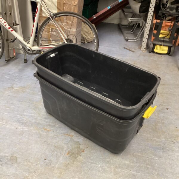 Two wheeled plastic storage boxes for home organisation.