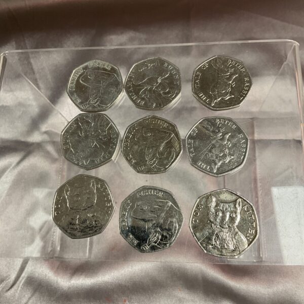 Lot of nine Beatrix Potter 50p coins, including Jeremy Fisher and Tom Kitten.
