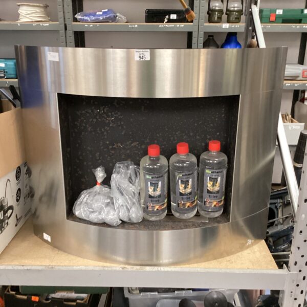 Modern bioethanol fireplace with fuel bottles and decorative coal.
