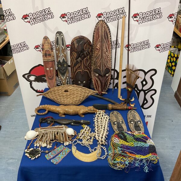 Collection of authentic African tribal masks and artifacts on display.
