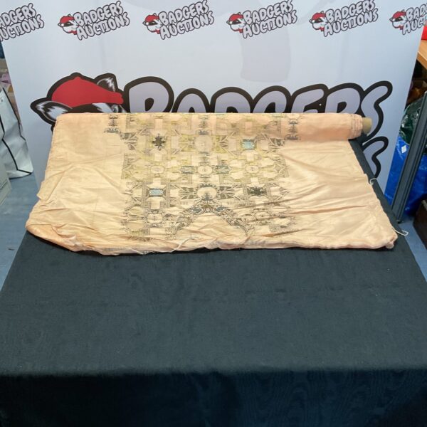 Vintage patterned silk roll, detailed fabric texture.