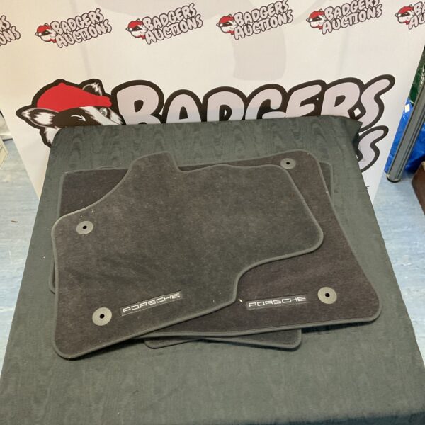 New Porsche floor mats set of four for car interior protection.