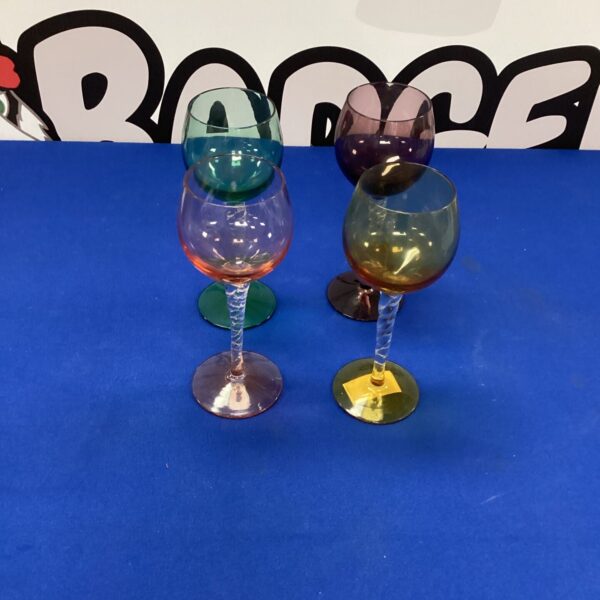 Set of four vintage coloured wine glasses in vibrant hues.