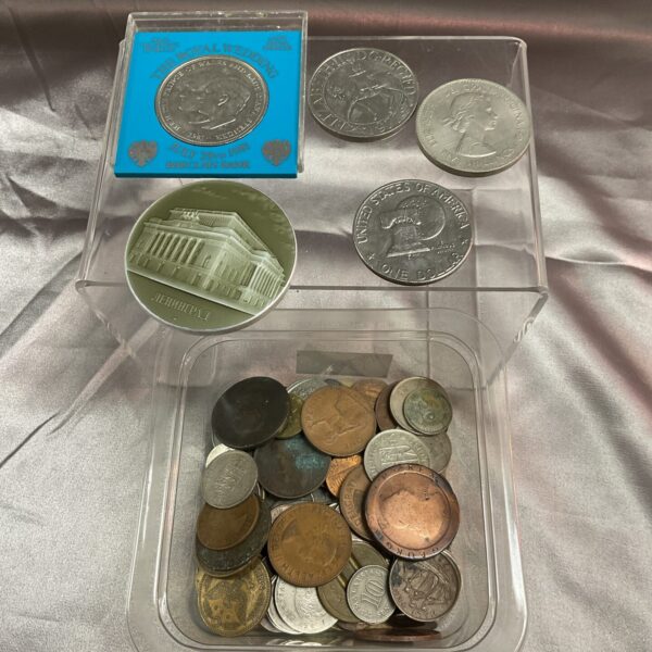 Close-up of assorted coin lot with commemorative and Liberty dollar.